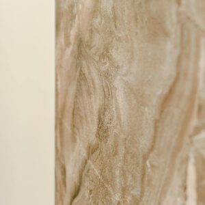 Close-up of a beige marble surface with natural patterns, perfect for design backdrops.