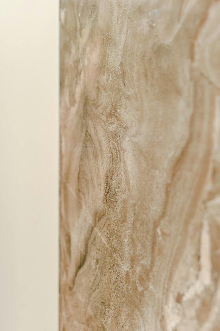 Close-up of a beige marble surface with natural patterns, perfect for design backdrops.