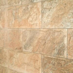 Detailed texture of a natural stone wall with earthy tones and rough surface.