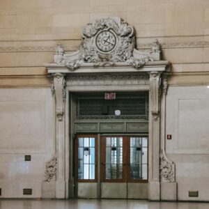 Elegant clock and doorway in Grand Central Terminal's historic interior.