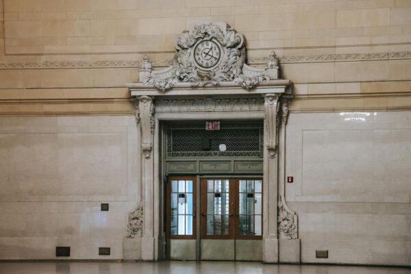 Elegant clock and doorway in Grand Central Terminal's historic interior.